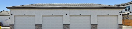 A large building with three garage doors.