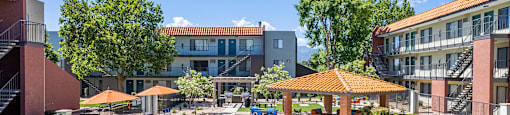 A swimming pool surrounded by lawn chairs and umbrellas.