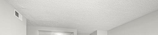 A room with a wooden floor and white walls.
