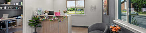 A reception area with a desk and chairs.
