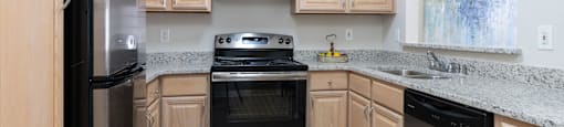 A kitchen with wooden cabinets and stainless steel appliances.