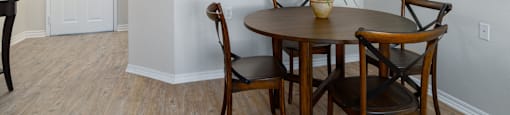 A dining room with a table set for two.