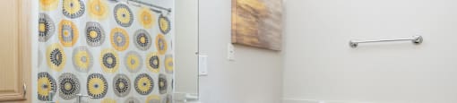 A bathroom with a toilet, sink, and a mirror.