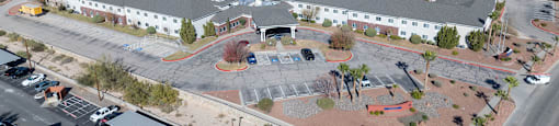 A large building with a parking lot in front of it.