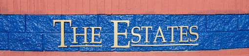 A wall with the words "The Estates" written on it.