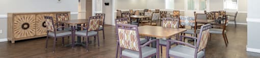 A dining room with a wooden table and chairs.