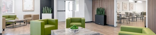A modern living room with green and grey furniture.