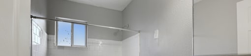 A white toilet sits next to a bathtub in a bathroom.