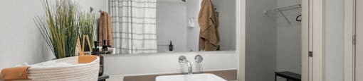 a white bathroom with a sink and a mirror