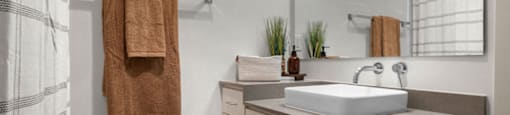 a bathroom with a sink and a shower and towels