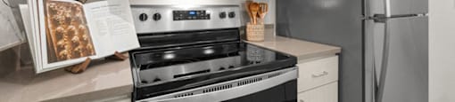 a kitchen with stainless steel appliances and white cabinets