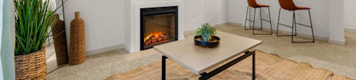 a living room with a fireplace and a table