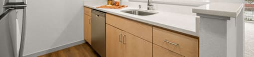 A kitchen with wooden cabinets and a white countertop.