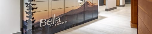 A wall mural in a hallway with the word "Bella" on it.