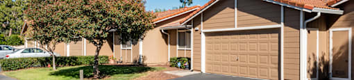 the front of a house with garage and trees at Oak Grove Terrace Concord, Oak Grove Rd