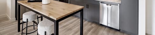 a kitchen with stainless steel appliances and a wooden table