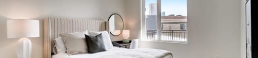 a bedroom with a large bed and a large window