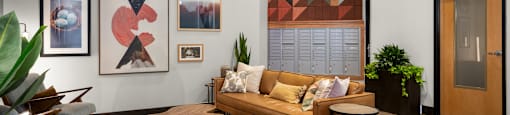 A modern living room with a wooden sofa, a coffee table, and a large abstract painting on the wall.