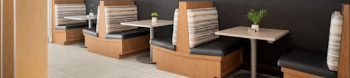 A restaurant with wooden booths and tables.