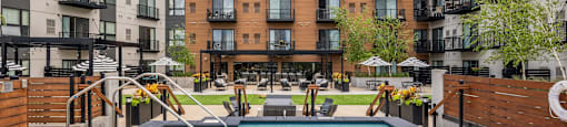 A swimming pool in a courtyard surrounded by apartment buildings.