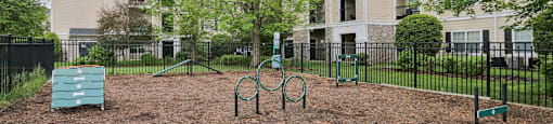 A playground area in front of apartment buildings.
