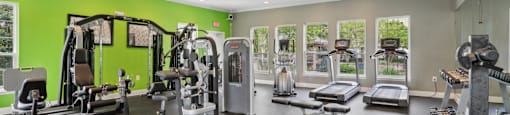 A spacious gym with a variety of equipment.