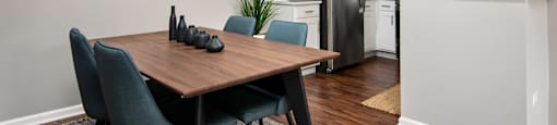 A modern kitchen with a dining table and chairs.