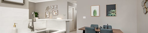 A kitchen with a dining table and chairs.