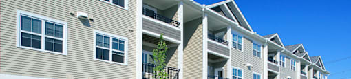 Apartment building with a clear blue sky above.