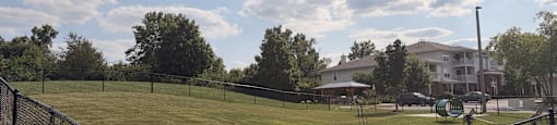 A black fence surrounds a grassy field.