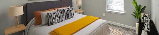 a bedroom with a large bed and a ceiling fan