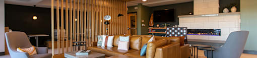 A modern living room with a wooden ceiling and a large sectional sofa.