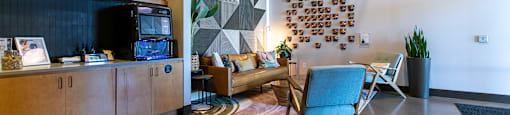 A living room with a blue chair and a brown floor.