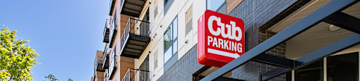 A red sign that says "Club Parking" is hanging over a building.