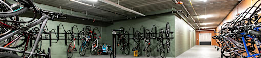 A bike storage room with bikes hanging on the wall.