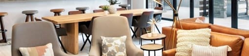 a living room with couches and chairs and a bar