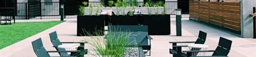 a group of benches sitting in front of an apartment building