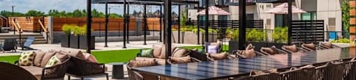a patio with tables and chairs and a pergola