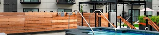 a swimming pool in front of an apartment building