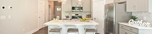 A modern kitchen with a dining area and a living room.