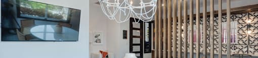 A white table with chairs and a chandelier in a room.