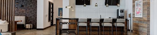 A modern kitchen with a dining table and chairs.