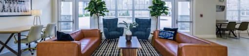 Ashland Farms Resident Clubhouse with Couch Seating, Large Windows, and View of Pool Area