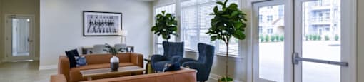 Ashland Farms Resident Clubhouse with Couch Seating, Modern Decor, and View of Pool Area