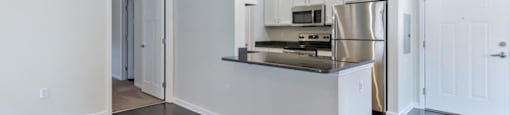 Ashland Farms Open Kitchen Layout with Island, Modern Light Fixtures, and Quartz Counters