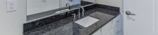 Ashland Farms Bathroom with Granite Counters, Single Sink Vanity, and White Cabinetry