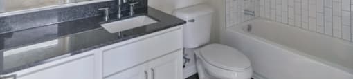 Ashland Farms Bathroom with Granite Counters, Modern Fixtures, and Shower Tub Combo
