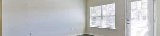 Ashland Farms Bright and Airy Living Room with Wood-Style Flooring, Ceiling Fan, and Large Windows