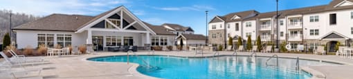 Apartments For Rent In Ashland City - Ashland Farms - Resort-Style Pool with Sundeck, Lounge Chairs, and View of Apartment Buildings
