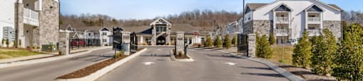 Ashland Farms Beautiful Gated Entrance to Apartment Community Surrounded by Lush Landscaping.